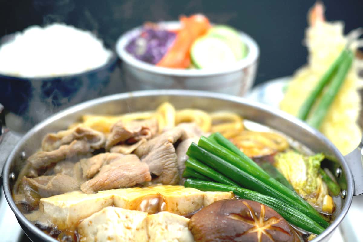Tender pork collar, tofu, cabbage, shiitake mushrooms, fresh green onions, & udon noodles simmered in our hot pot using a shoyu base sauce. Served with assorted tenpura, rice, and salad.