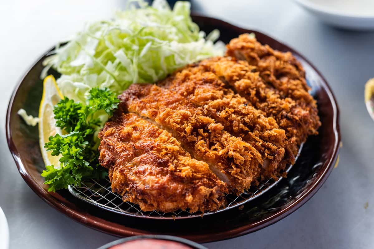 Plate of Chicken Katsu with thinly shredded cabbage