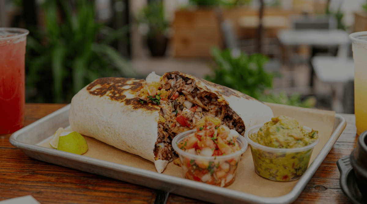 Grilled Burrito Famous burrito packed with seasoned meat, rice, beans, and fresh toppings, served with house-made guacamole, pico de gallo, and a fresh lime wedge.