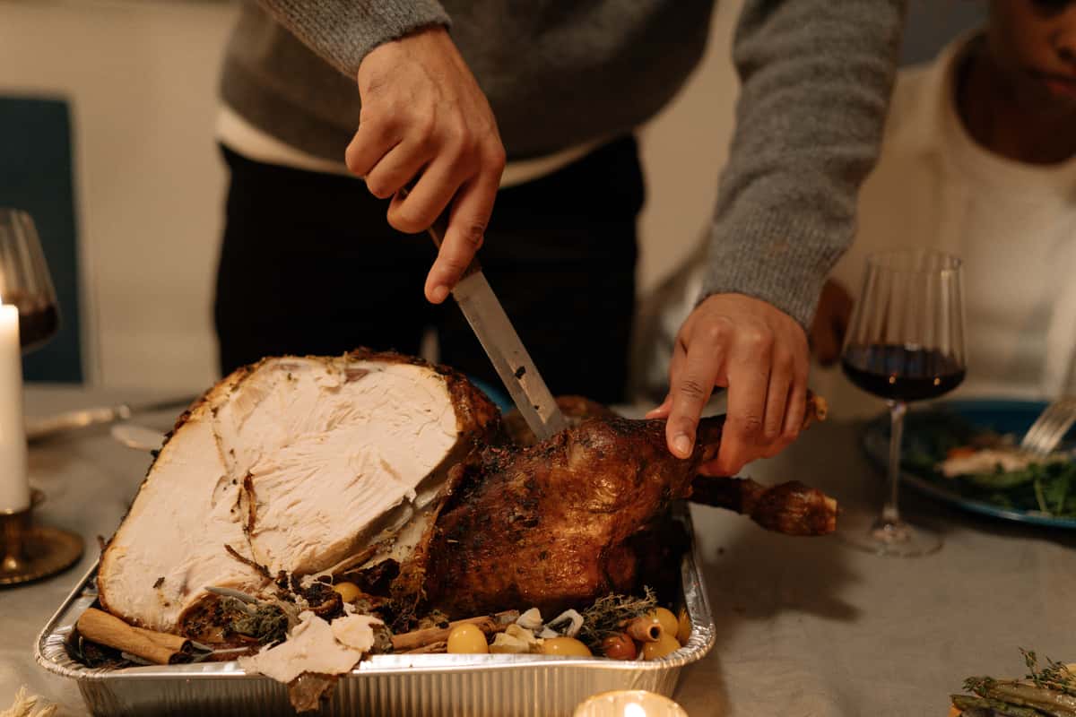 Person carving a turkey.