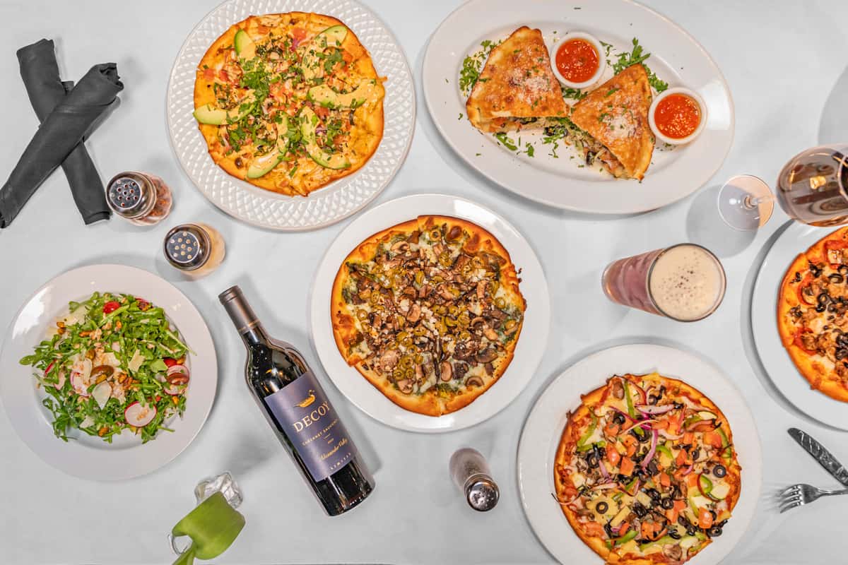 group shot of food including pizza and wine