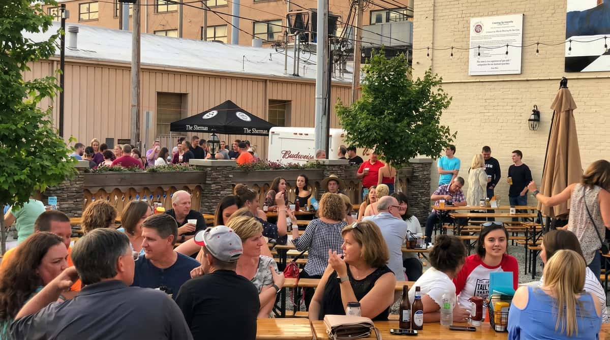 Outdoor crowd gathered at a restaurant patio or beer garden