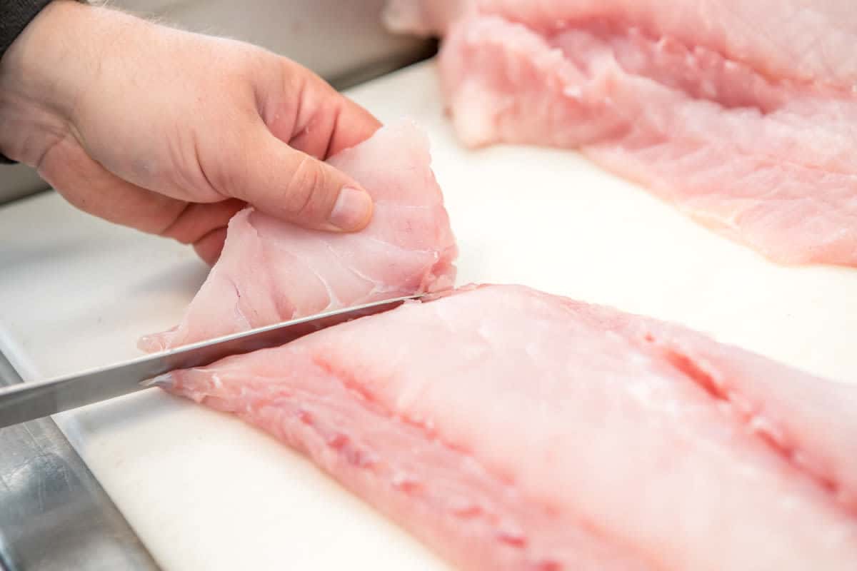 Fresh caught fish being butchered by a chef