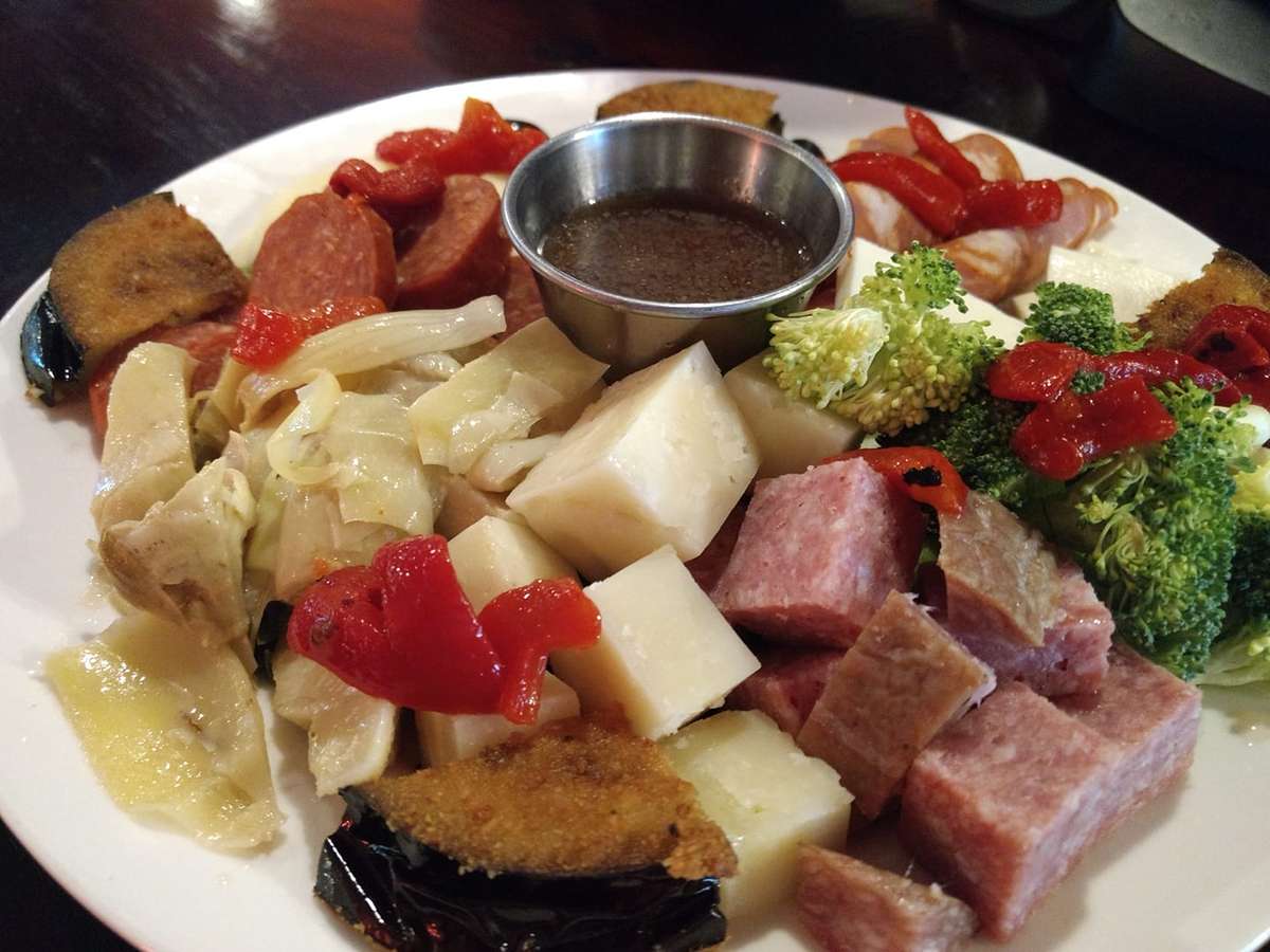 antipasto salad with italian meats and cheeses served with olives and vegetables