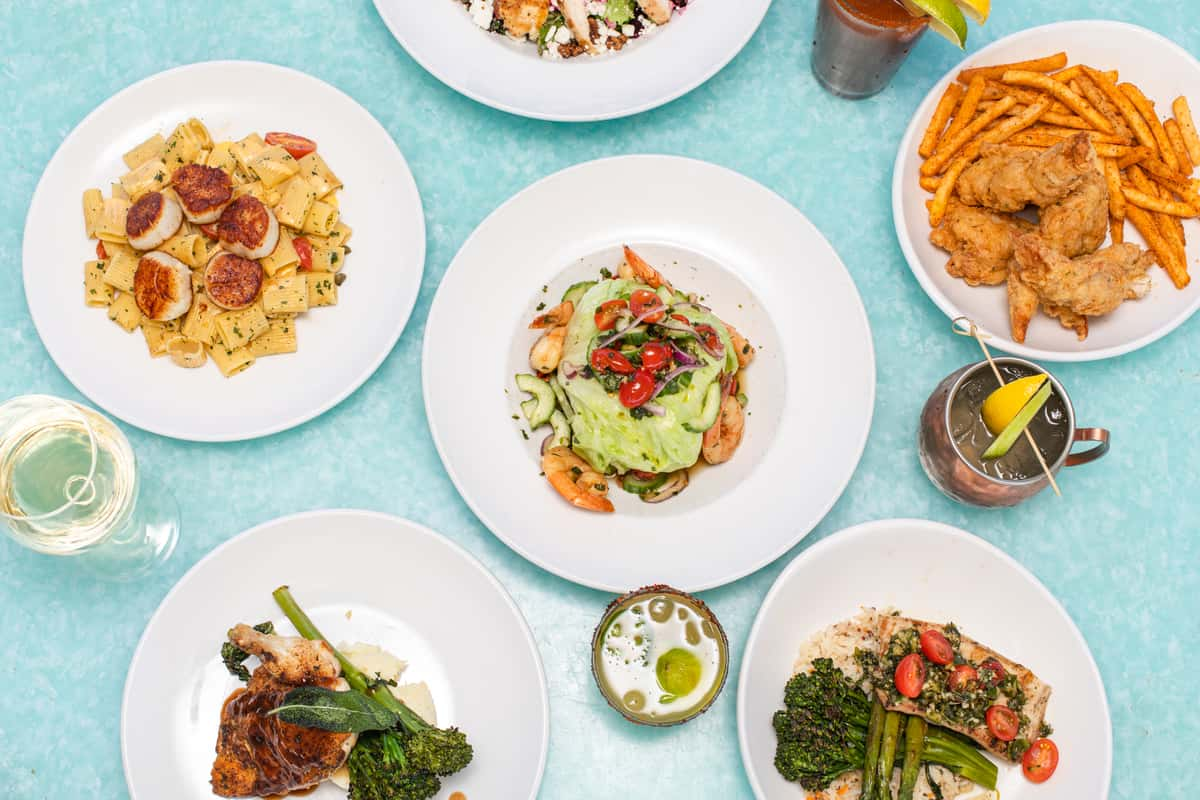 A table full of a variety of entrees and drinks