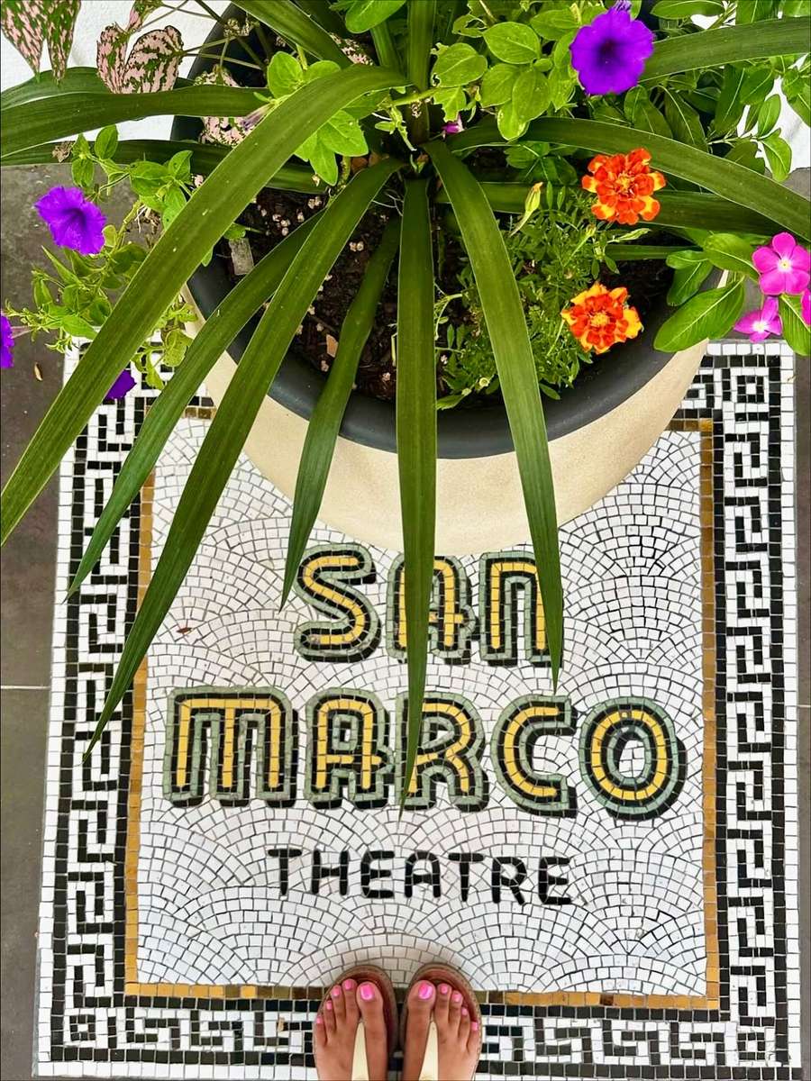 The original San Marco Theatre mosaic set into the terrazzo floor at the entrance to Electric Dough Pizza Co.