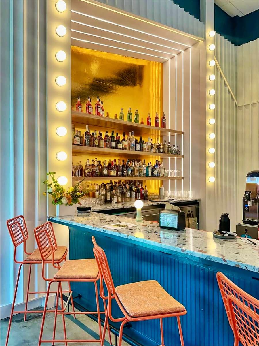 The bar at Electric Dough Pizza Co. in San Marco, Jacksonville, with its bulb-lit frame and terrazzo counter.