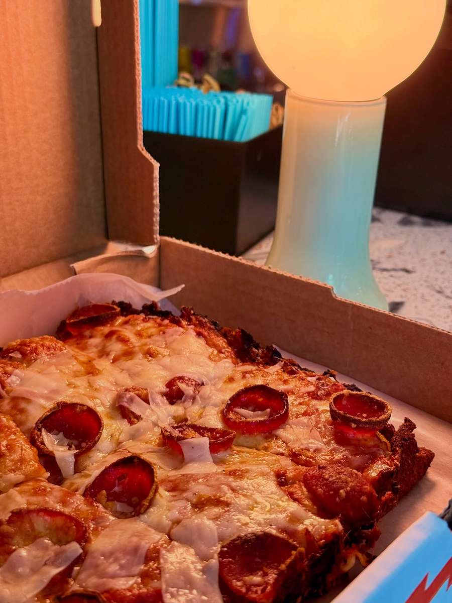 A pepperoni pan pizza at Electric Dough Pizza Co. in San Marco, Jacksonville, with cheese caramelized to the edge of the pan.