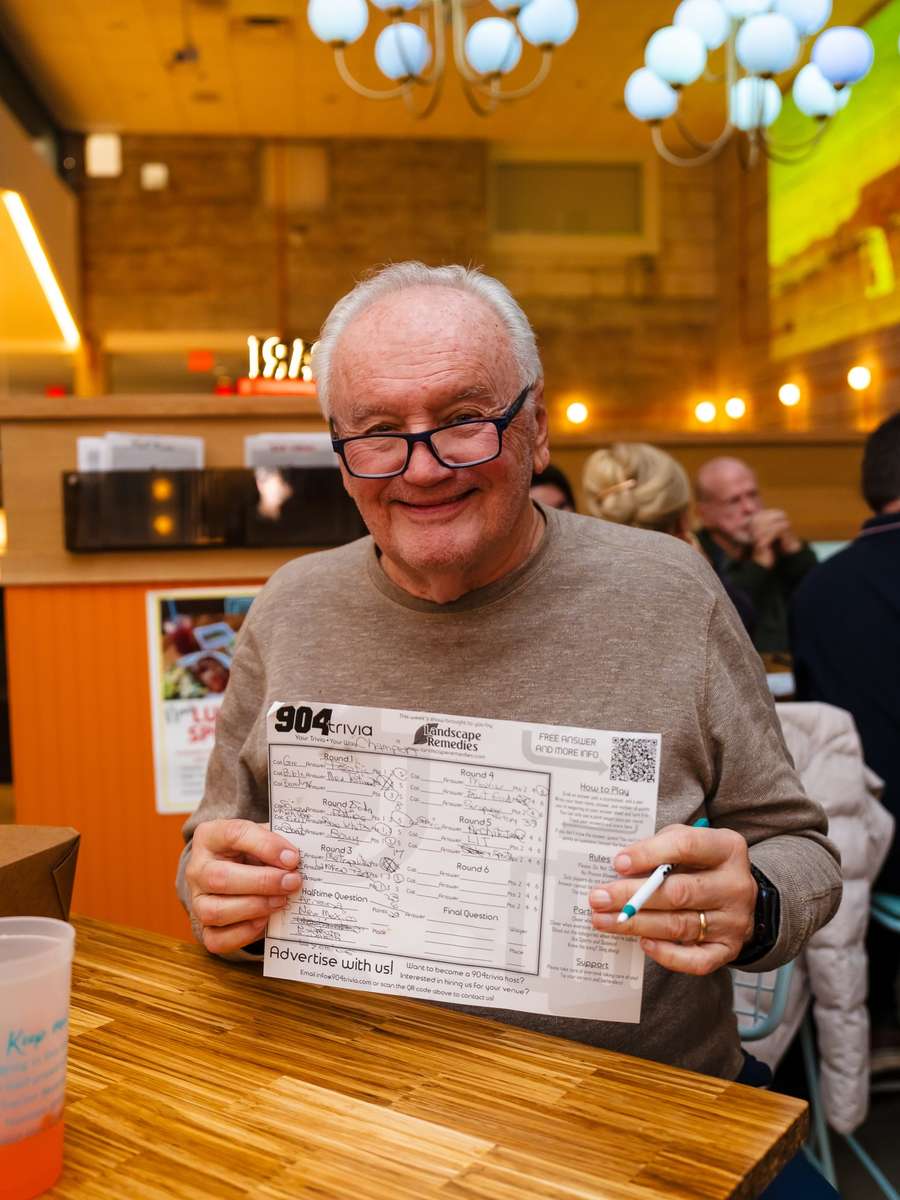 A regular grinning with his sheet on 904 trivia night at Electric Dough Pizza Co.