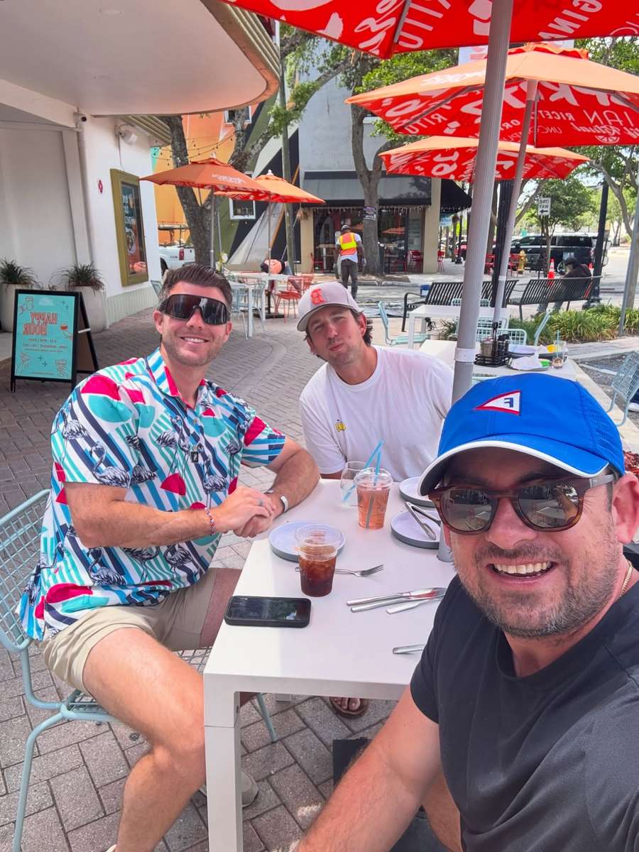 Friends laughing over lunch at an outdoor table on San Marco Square.