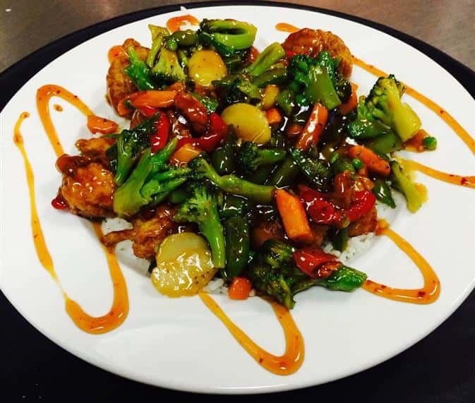 asian stir fry bowl. Grilled strips of chicken, mixed Asian vegetables, served over a bed of steamed white rice tossed with your choice of Teriyaki or General Tso sauce. 