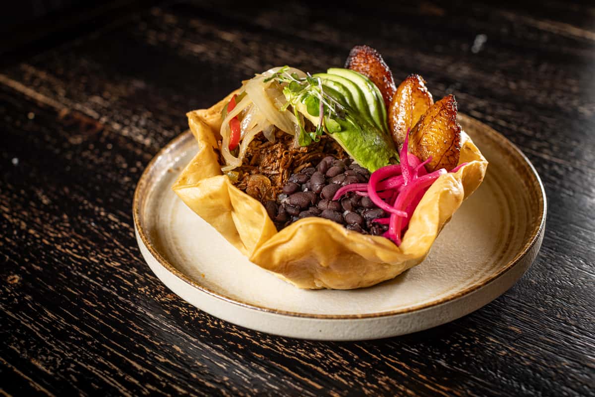 Black beans, white rice, sliced avocado, pickle red onions, sweet plantains served in a crispy tortilla bowl