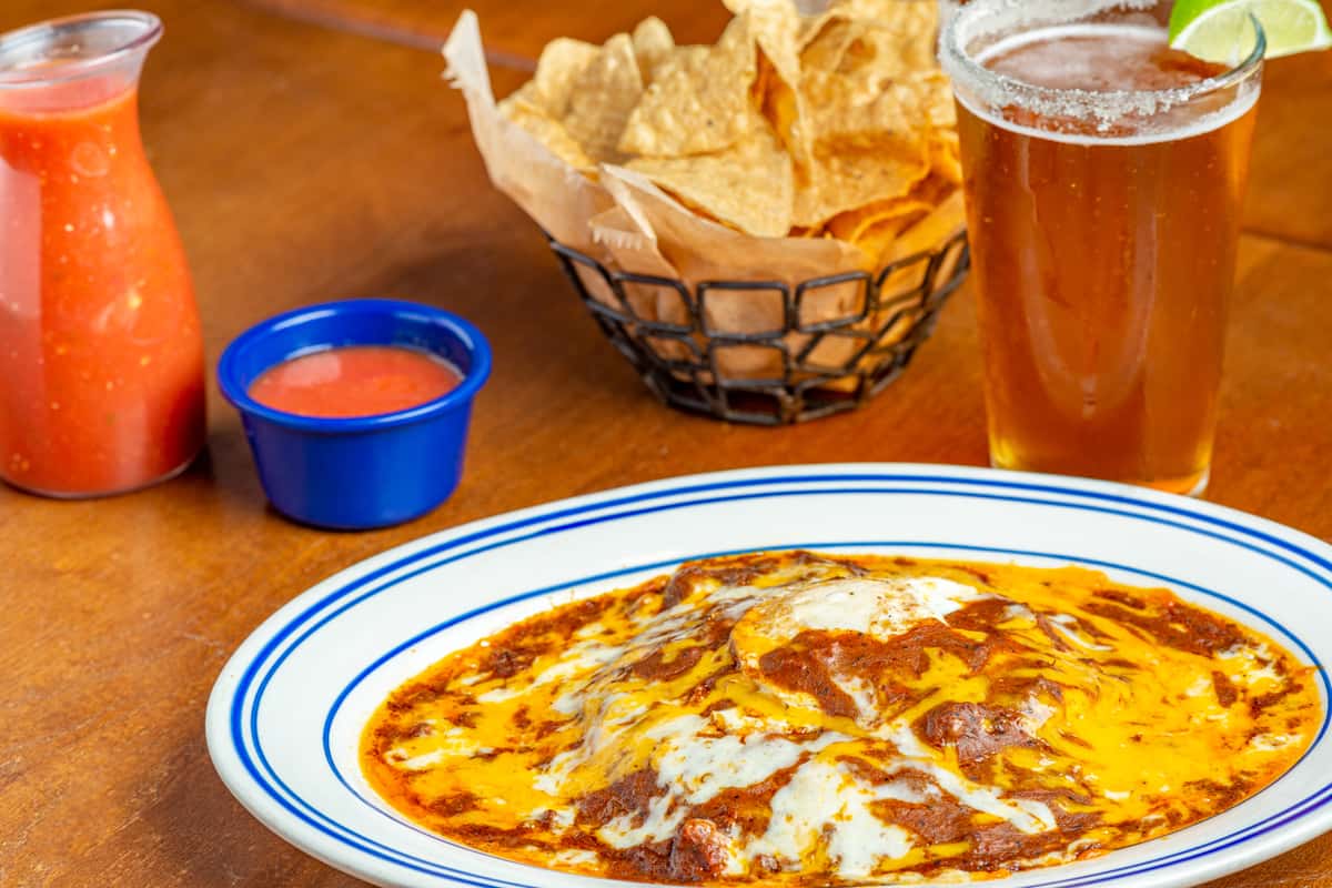 Pancake style, meat, cheese, onion & fried egg covered with chile