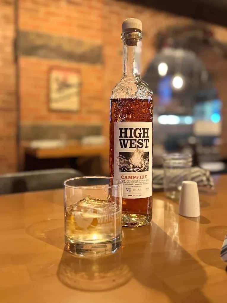 High West bottle of alcohol with glass of ice