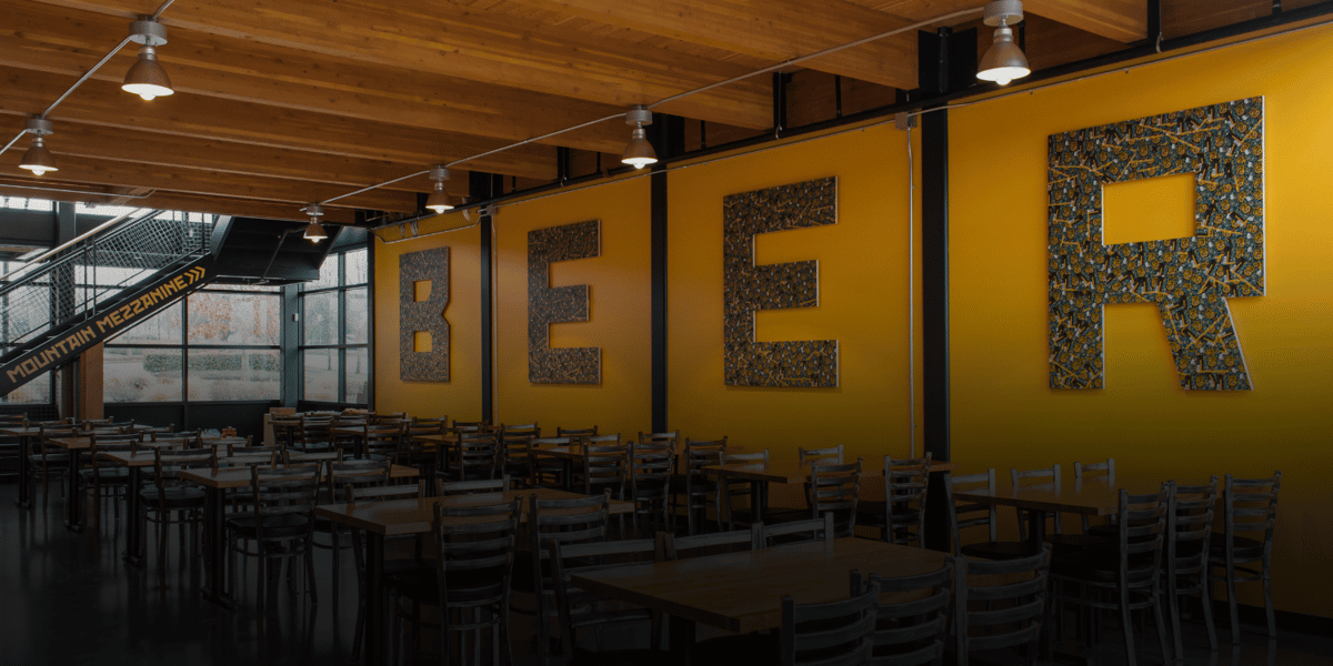 vancouver dining room with a large art installation on the wall that says 'BEER'