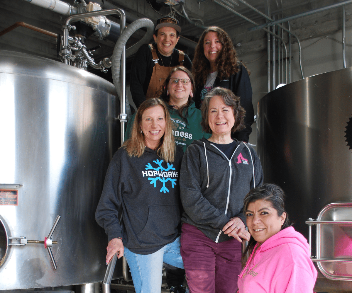 pink boots society and hopworks collab brew, smiling faces of 6 ladies brewing