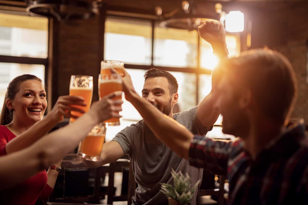 friends toasting with pints of beer