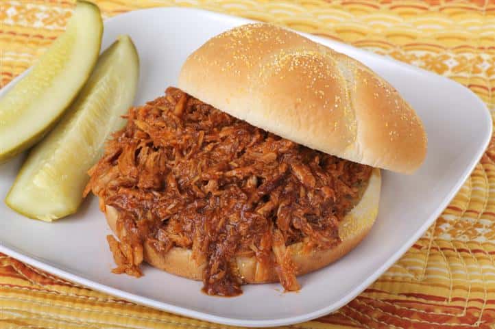 pulled pork sandwich with pickle spears