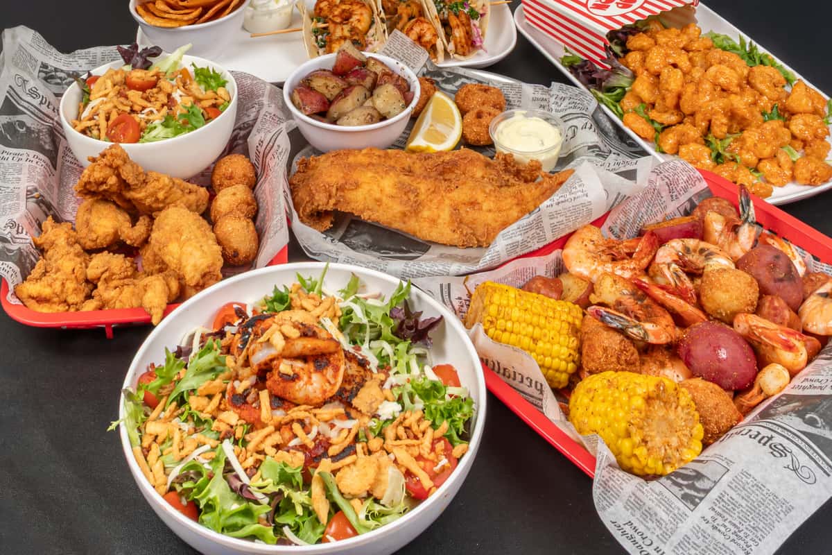 spread of food in top view including salads and fried foods