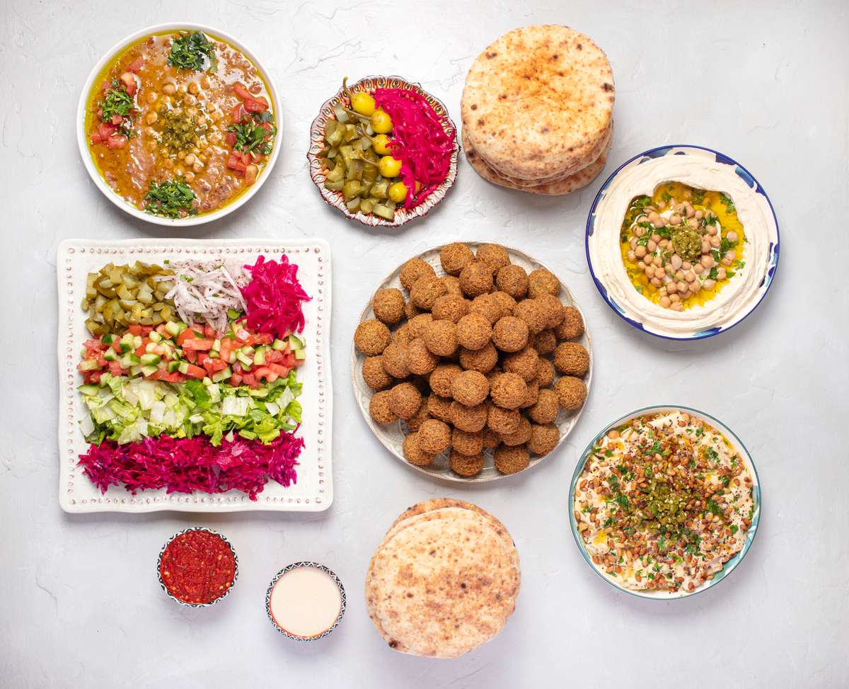 -Feeds up to 12 people- Includes: 60 Falafel, 12 Pitas, Hummus bowl, Fatteh bowl, Foul bowl, Half tray of sababa salad, pickled red cabbage, mixed pickles, Tahini, Shatta (Red spicy sauce).