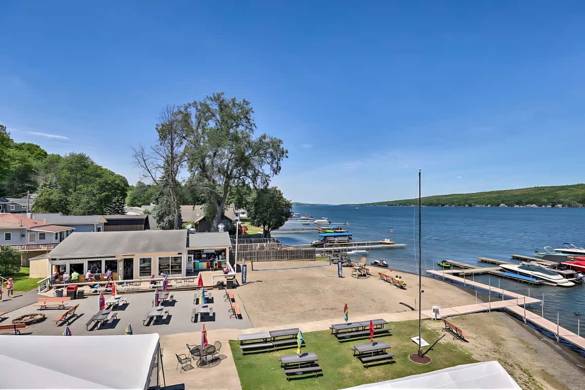 Aerial view of Beachcomber outdoor seating area and lakefront patio beside Conesus Lake.