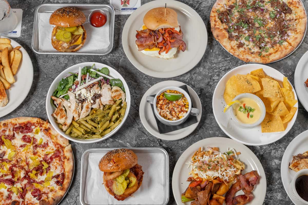 Hero images of multiple dishes at District 7 grill in houston tx