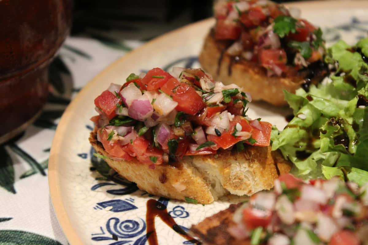 Tomato bruschetta on toasted bread with herbs
