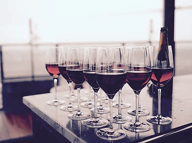 multiple glasses of red wine on table