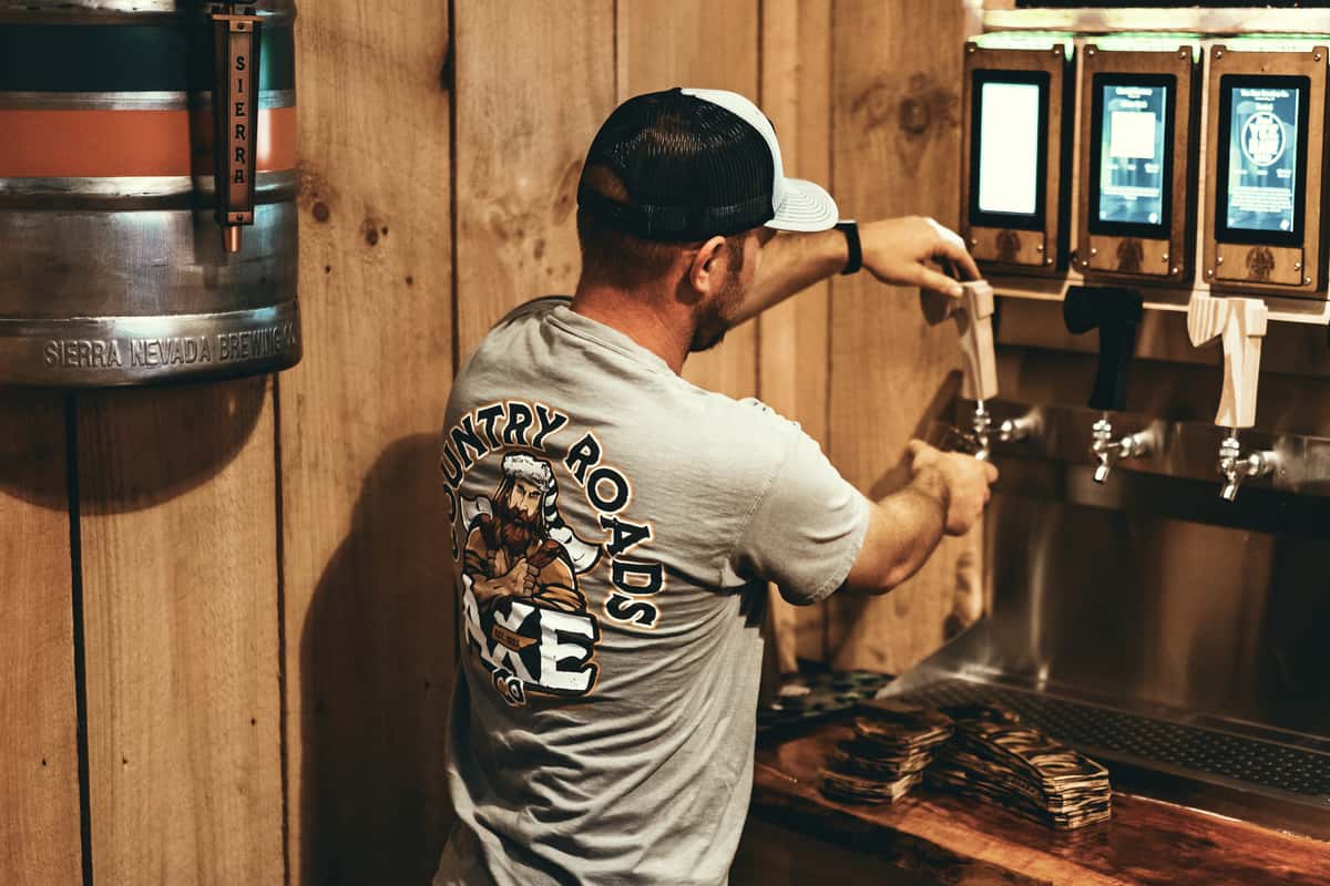 Employee pouring beer