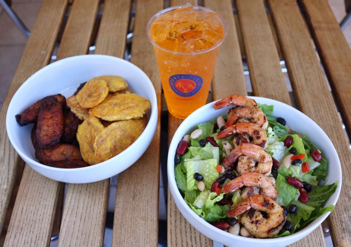fried plantains, grilled shrimp salad, and iced beverage