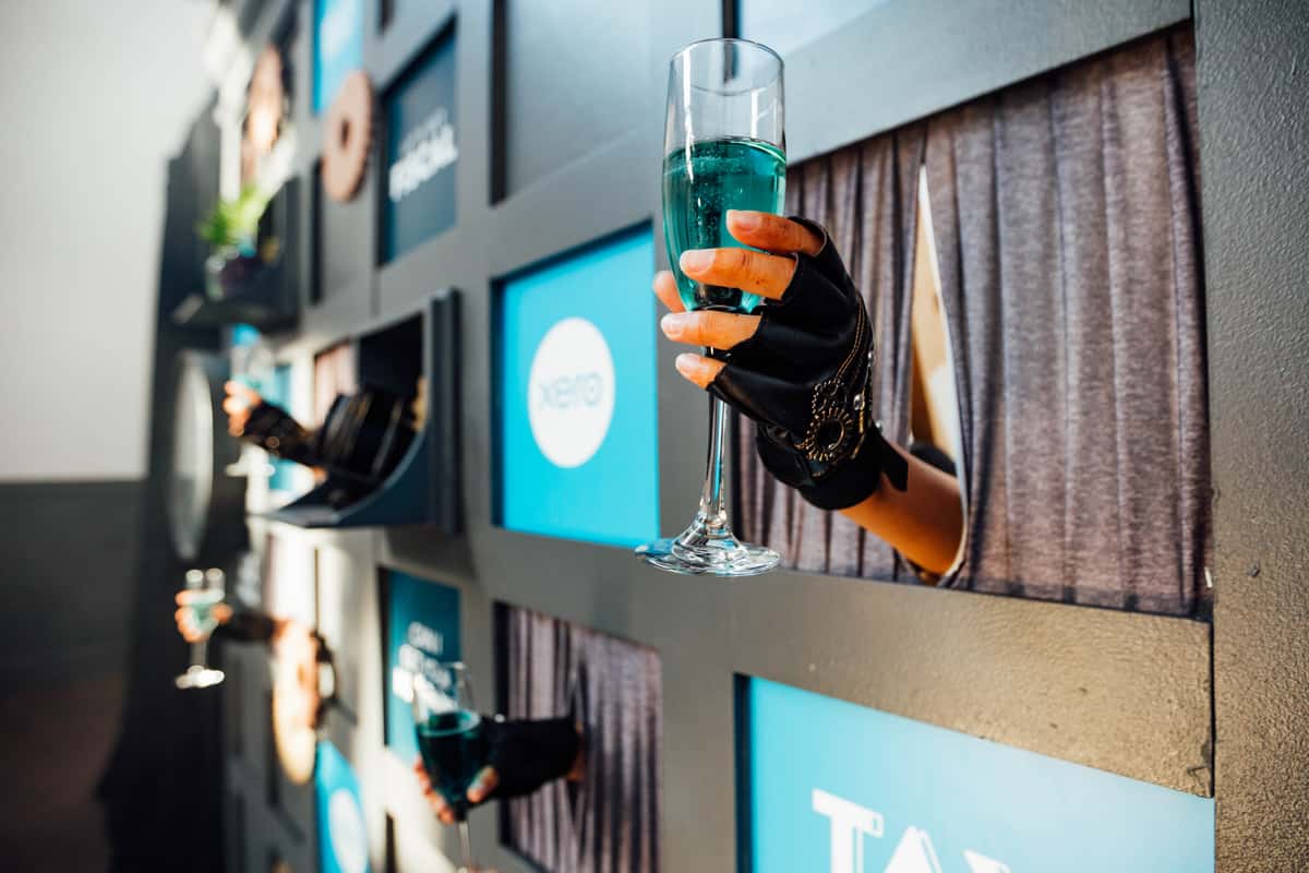 Hand serving a drink from a wall
