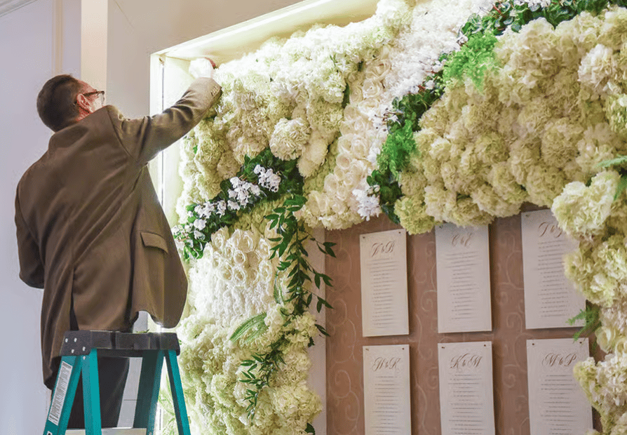 floral designer on a ladder