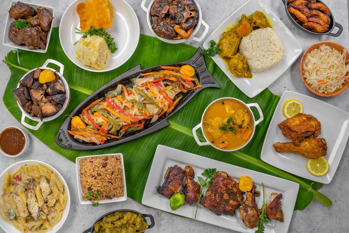 a variety of Jamaican dishes on a table