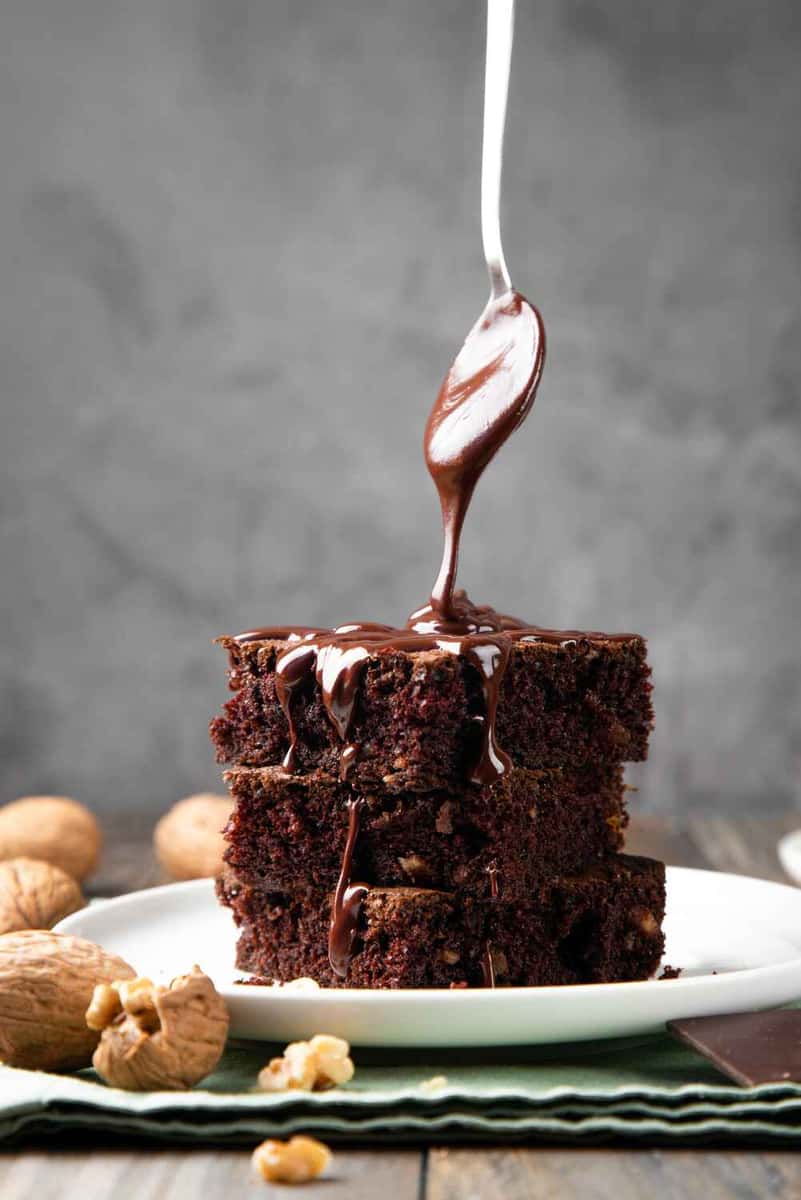 stack of brownies with chocolate dripping on it