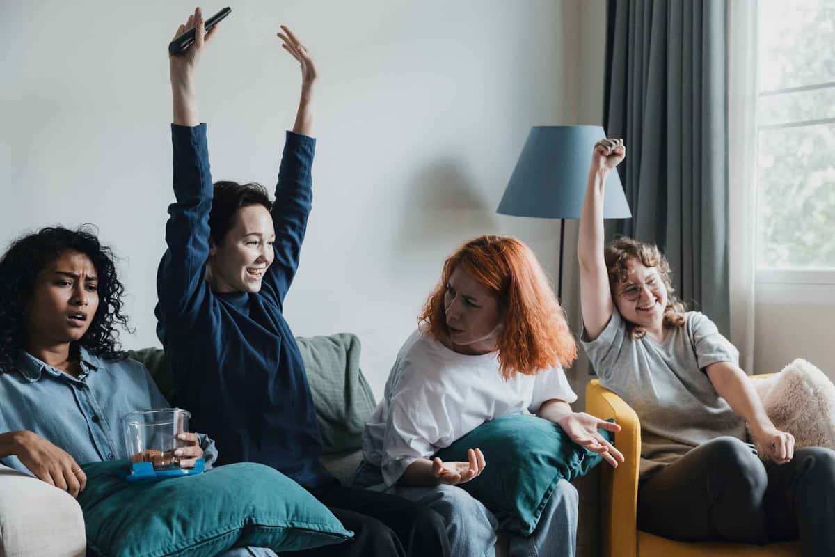 four people watching a game