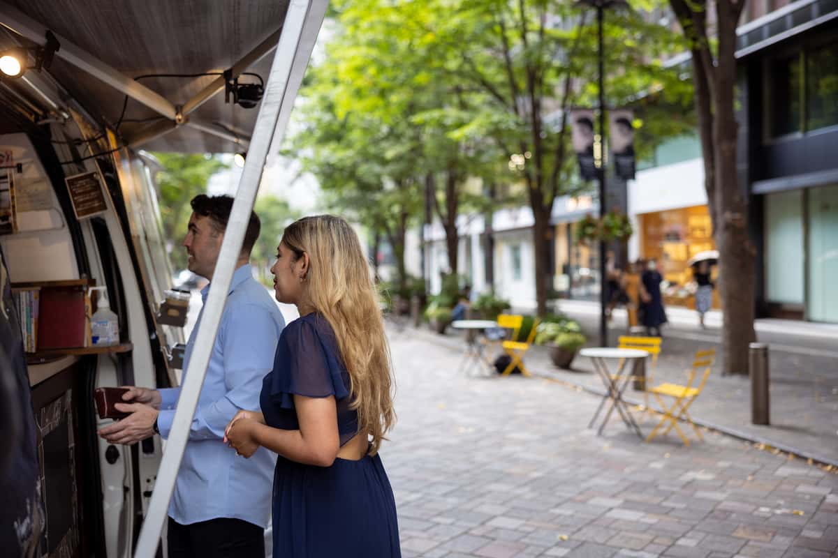 two people in front of a food truck