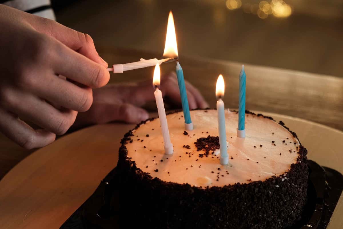 birthday cake with candles being lit