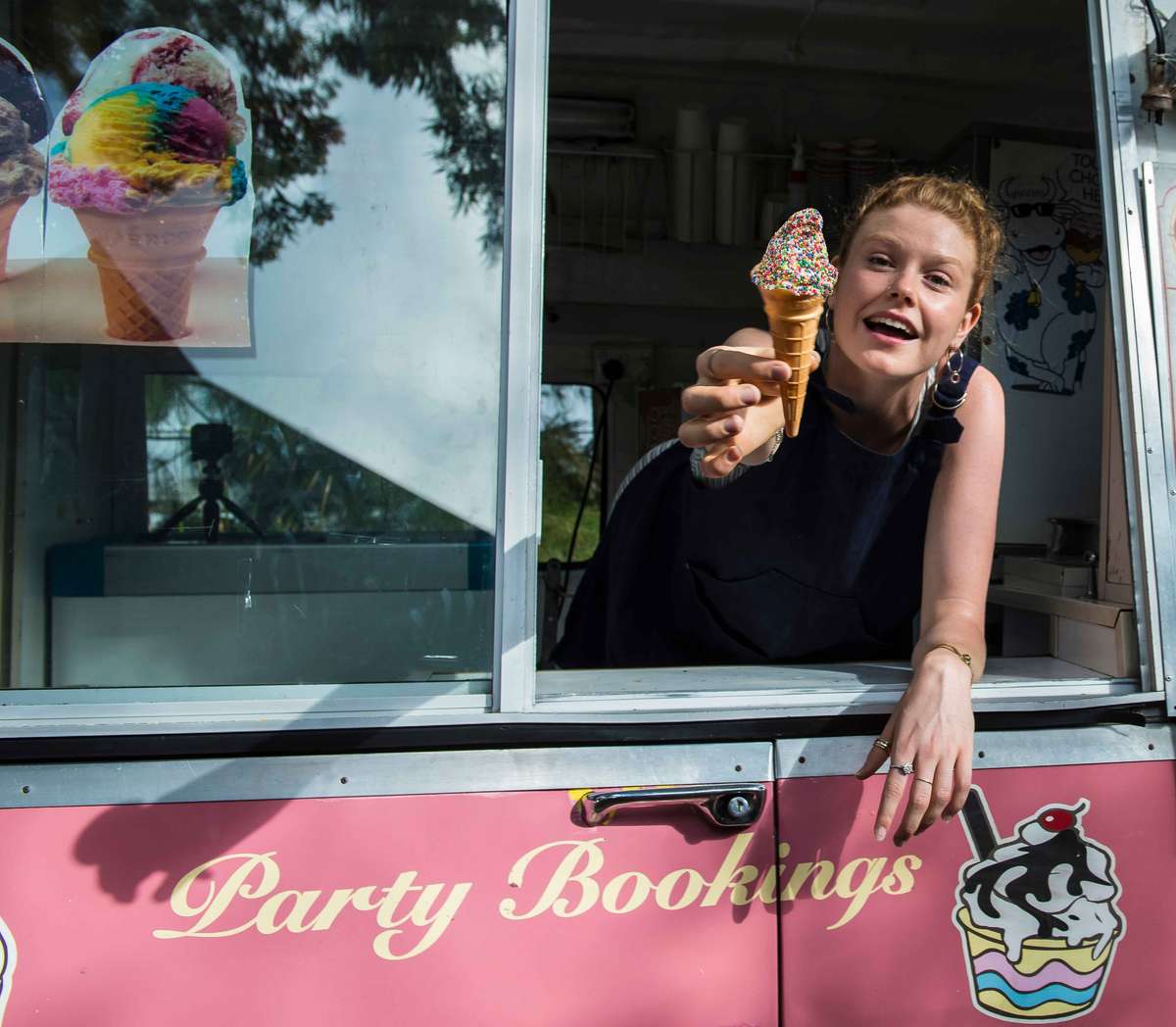 woman offering ice cream inside a food truck