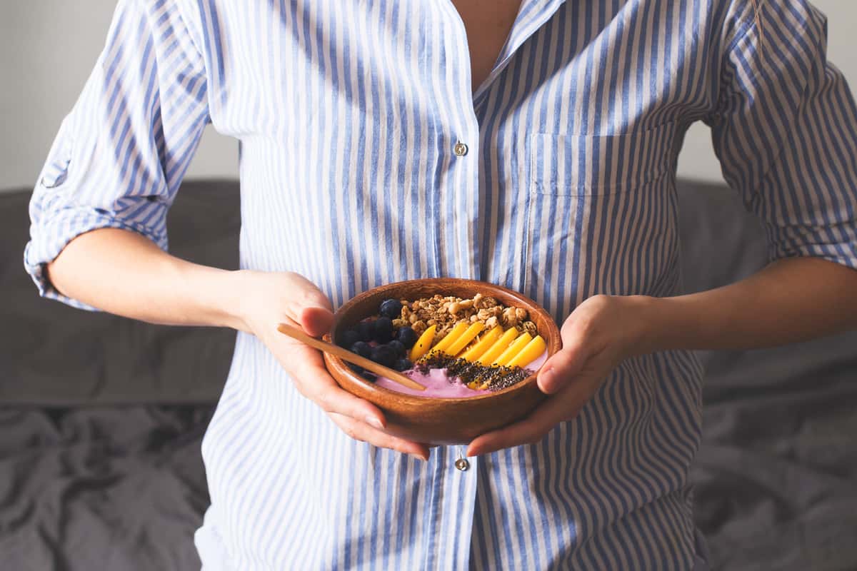pregnant woman with a dessert bowl