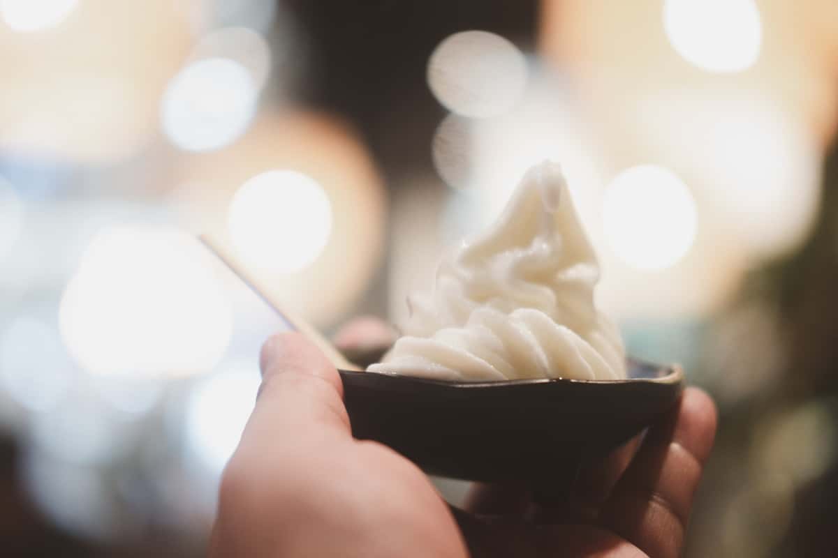 holding a cup with soft serve