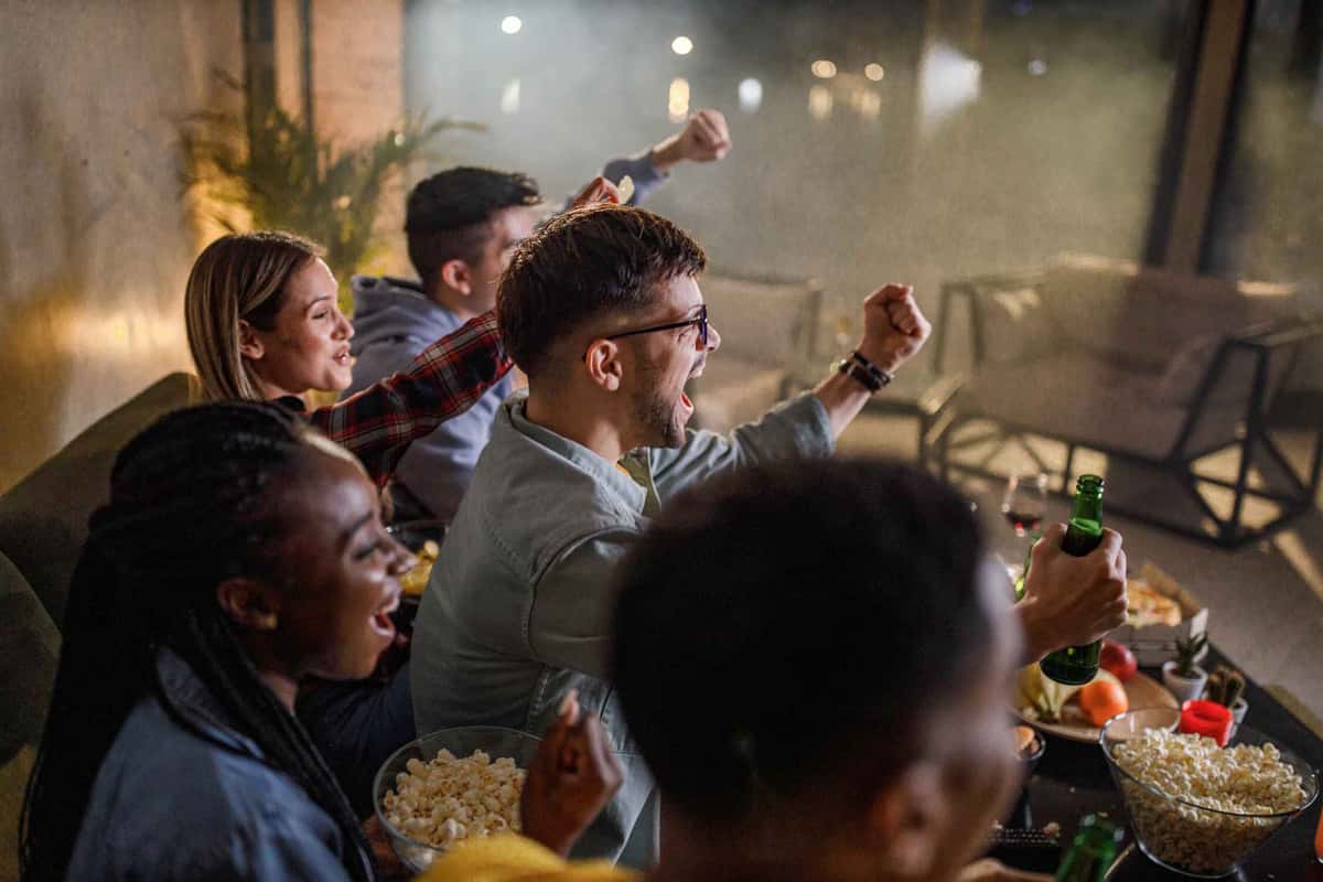 people celebrating while watching a game