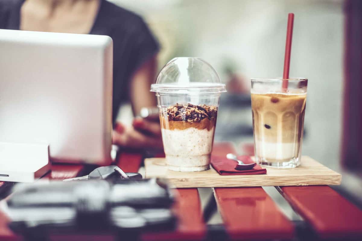 person working with coffee and dessert