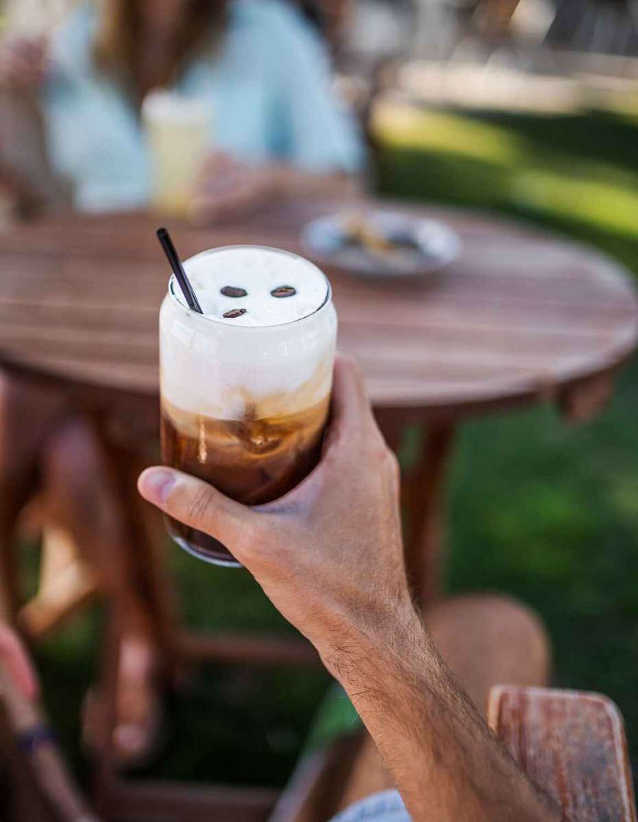 coffee with cream held in hand