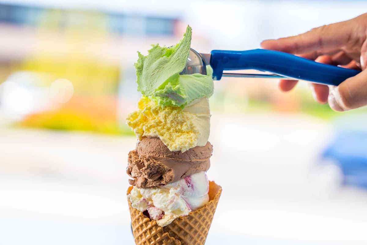 four different scoops of ice cream in one cone