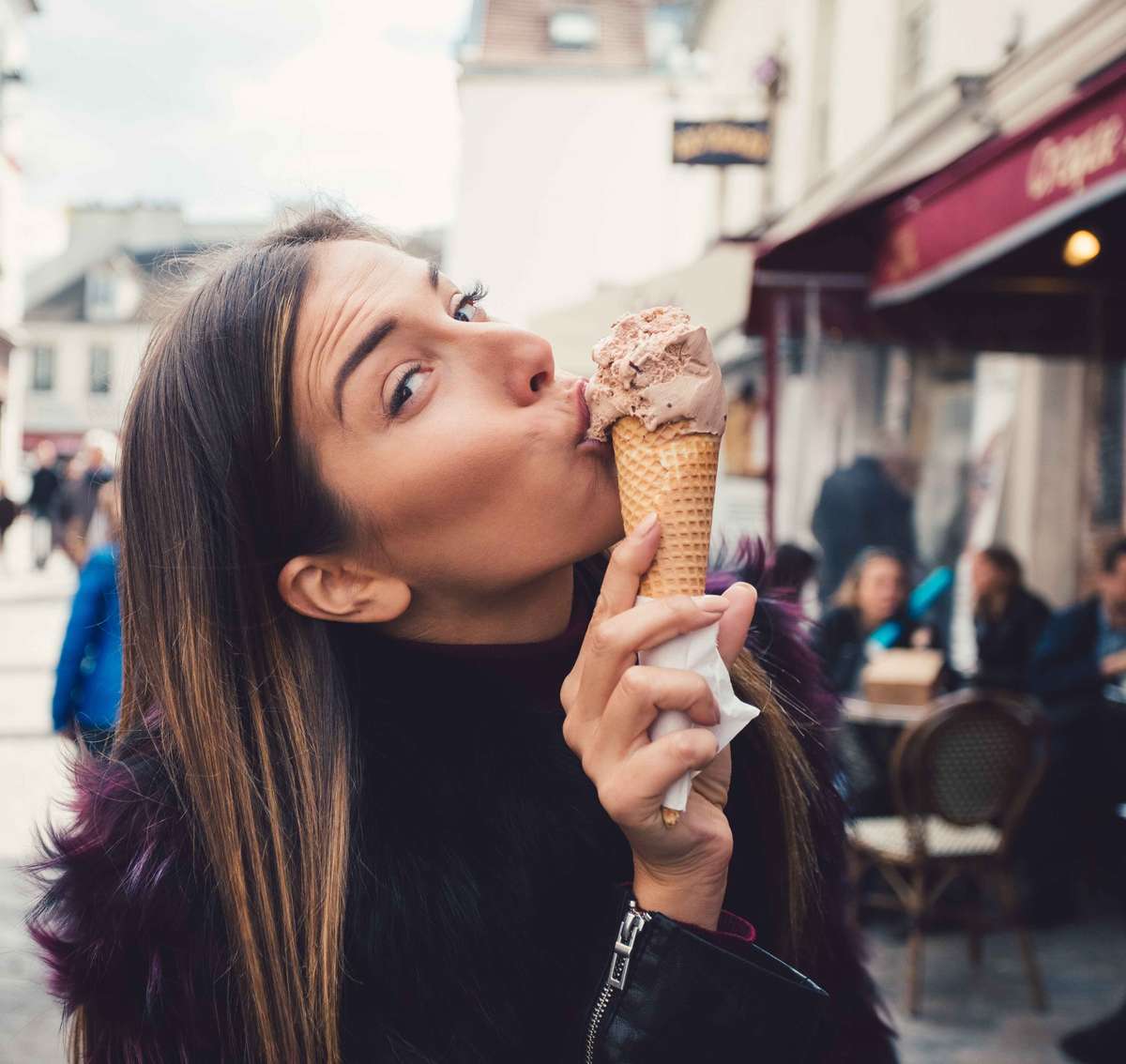 woman wearing black eating ice cream