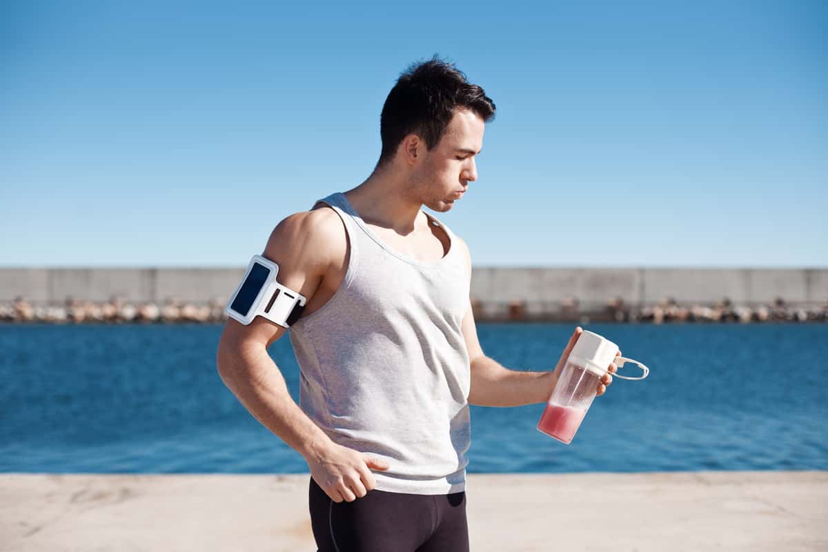 man running with a drink