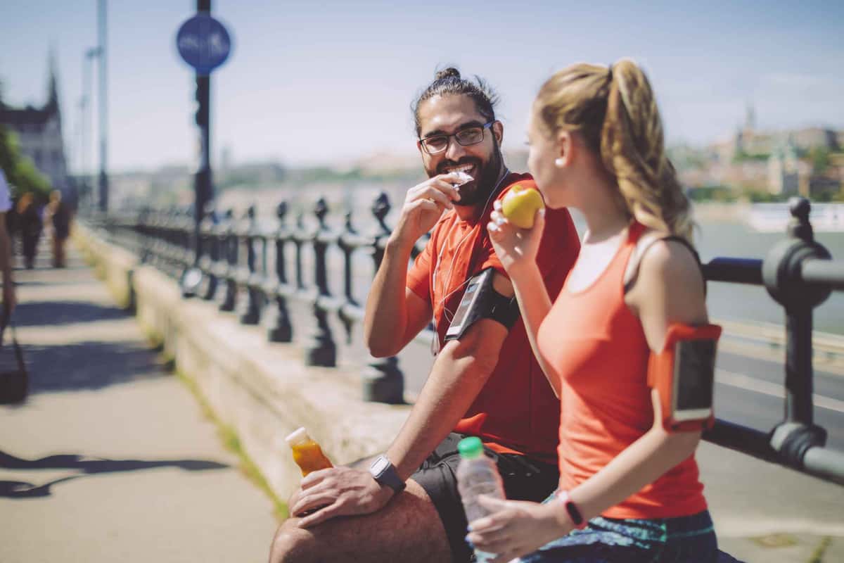 man and woman sitting down and having a snack