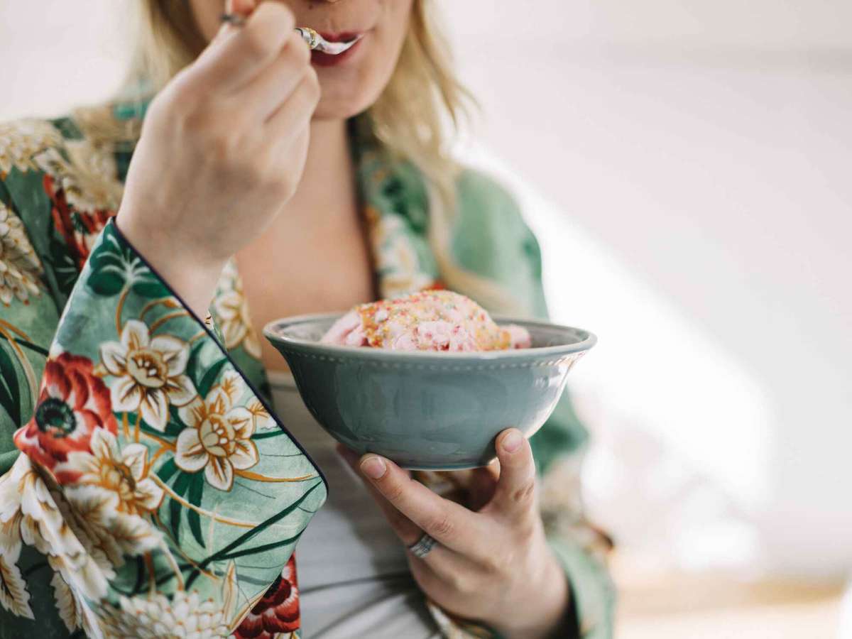 pregnant woman eating an ice cream in a bowl