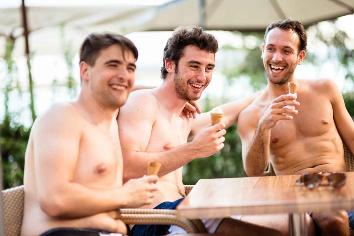 three men holding ice creams