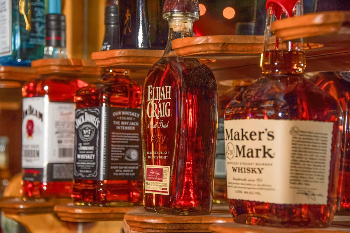 Whiskey bottles lined up behind the bar at Blackwell Revival in Atkins, Arkansas, highlighting a full-service bar selection